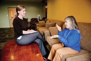 Betsy “Bets” Wohl (right) uses sign language to communicate with  interpreter Christina Healy. (David Stuck)