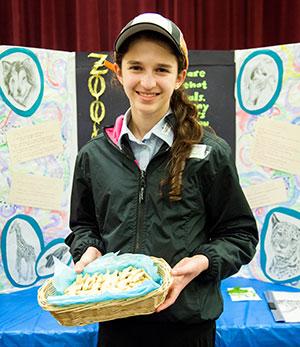 Rivka Hutman shows off her research in the field of zoology at Bnos Yisroel’s career day. 