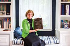 Mary Jo Giulioni proudly displays a plaque that honors her 30 years as a Torah Institute educator. (Justin Tsucalas)