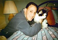 Moses Montefiore Anshe Emunah member Robbie Silverman, pictured with his cat, Sylvester, says the synagogue’s pet memorial board will help bring pet owners together. (Provided)