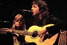 Former Beatle Paul McCartney performs “Getting Better” in 1976.  His ex-wife, Linda, is also pictured. (Jim Summaria via Wikimedia Commons)