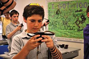 A Beth Tfiloh Dahan Community School student adorns the pair of tefillin he crafted at school. (Photos by David Stuck)