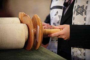 Among the issues Conservative synagogues are debating is whether a non-Jewish parent may stand near the Torah during his or her child's bar or bat mitzvah. (Konstantin Goldenberg/Shutterstock)
