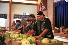 Carl “Diesel” Galler (second from right) and members of Motorcycle Club Five give food to the needy at one of the Community Crisis Center’s food giveaways in Reisterstown. (Marc Shapiro)