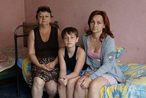 Ludmila Lazaurenko (right), son Anatoly and mother Nadezhda  Belovol live in temporary housing near Dnepropetrovsk, Ukraine. (Photos Cnaan Liphshiz)