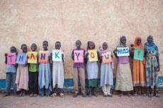 Happy refugees at Farchana in Chad spell out “Thank You HIAS!”  (Photo by Glenna Gordon/HIAS)
