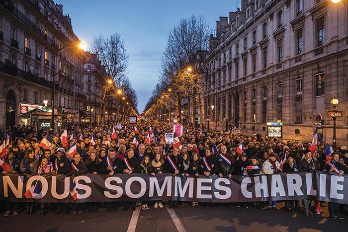 Demonstrators carrying a sign reading “We Are Charlie” march in a Paris square during a unity rally following the terrorist attacks in the French capital. (Dan Kitwood/Getty Images)