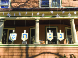 Snowflakes and eight supersized spinning dreidels displaying Hebrew letters adorn the McGinitys’ home. (Photo by Keren McGinity)