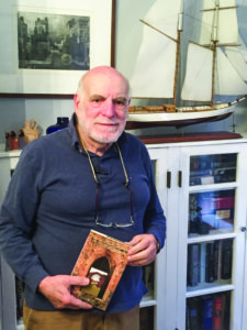 Harry Ezratty holds a copy of his book, “500 Years in the Jewish Caribbean.” (Photo by Daniel Nozick)